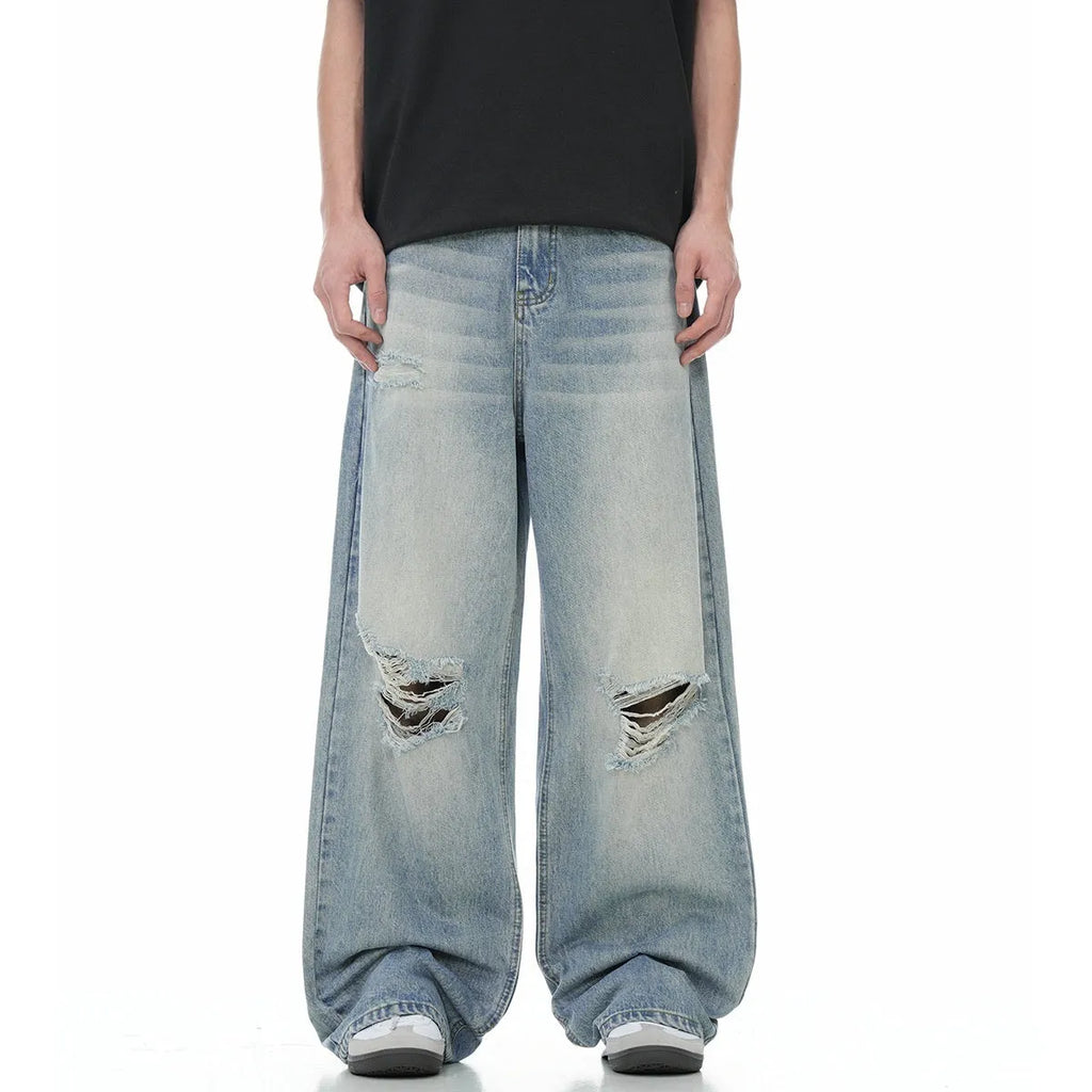 Blue cotton blend men's straight leg jeans with retro ripped detailing, front view, zipper fly, standing pose