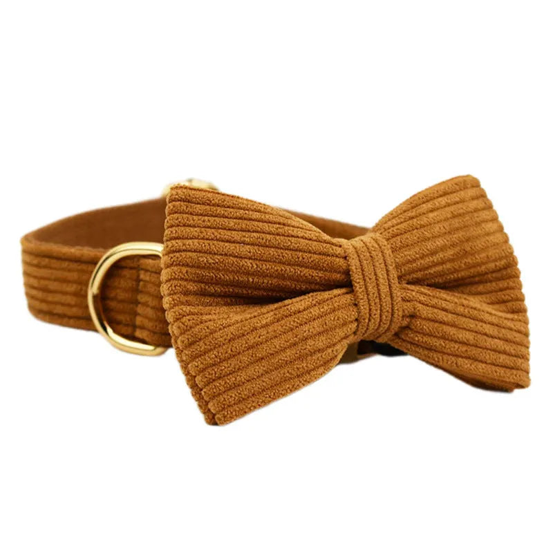 Caramel corduroy pet collar set with ring, rope, bow, vest, and poop bag on a light background