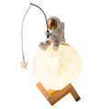Gold astronaut resin figurine USB humidifier and night light on a wooden base