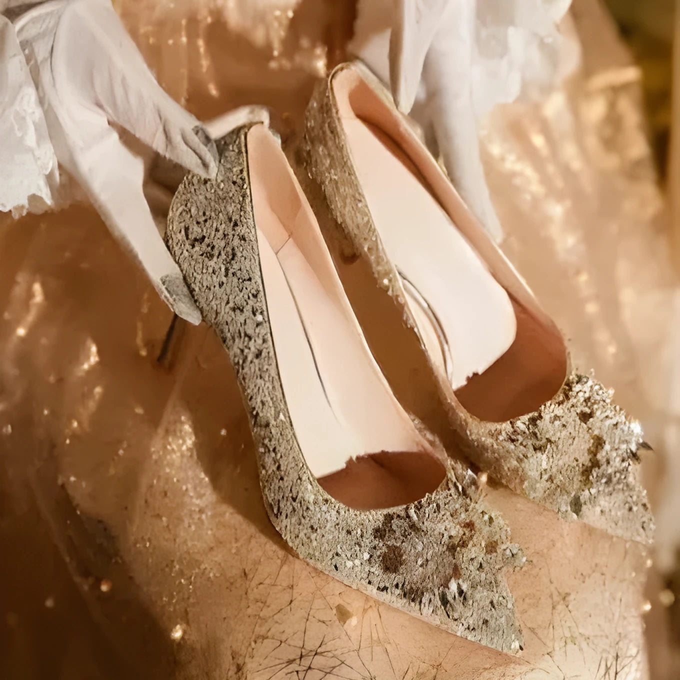 Champagne coloured women's wedding shoes with rhinestone flower pattern, pointed toe, and a fine heel.