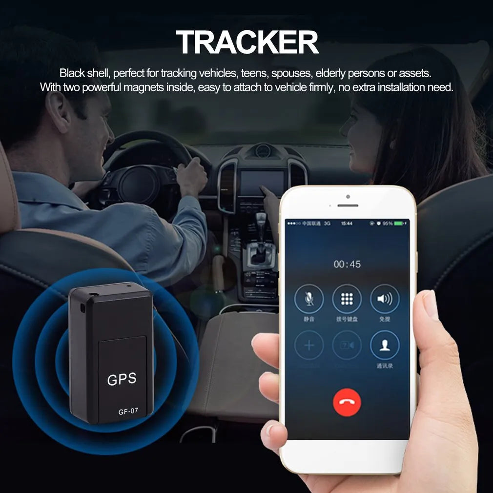 Small black plastic magnetic GPS tracker device next to a USB charging cable.