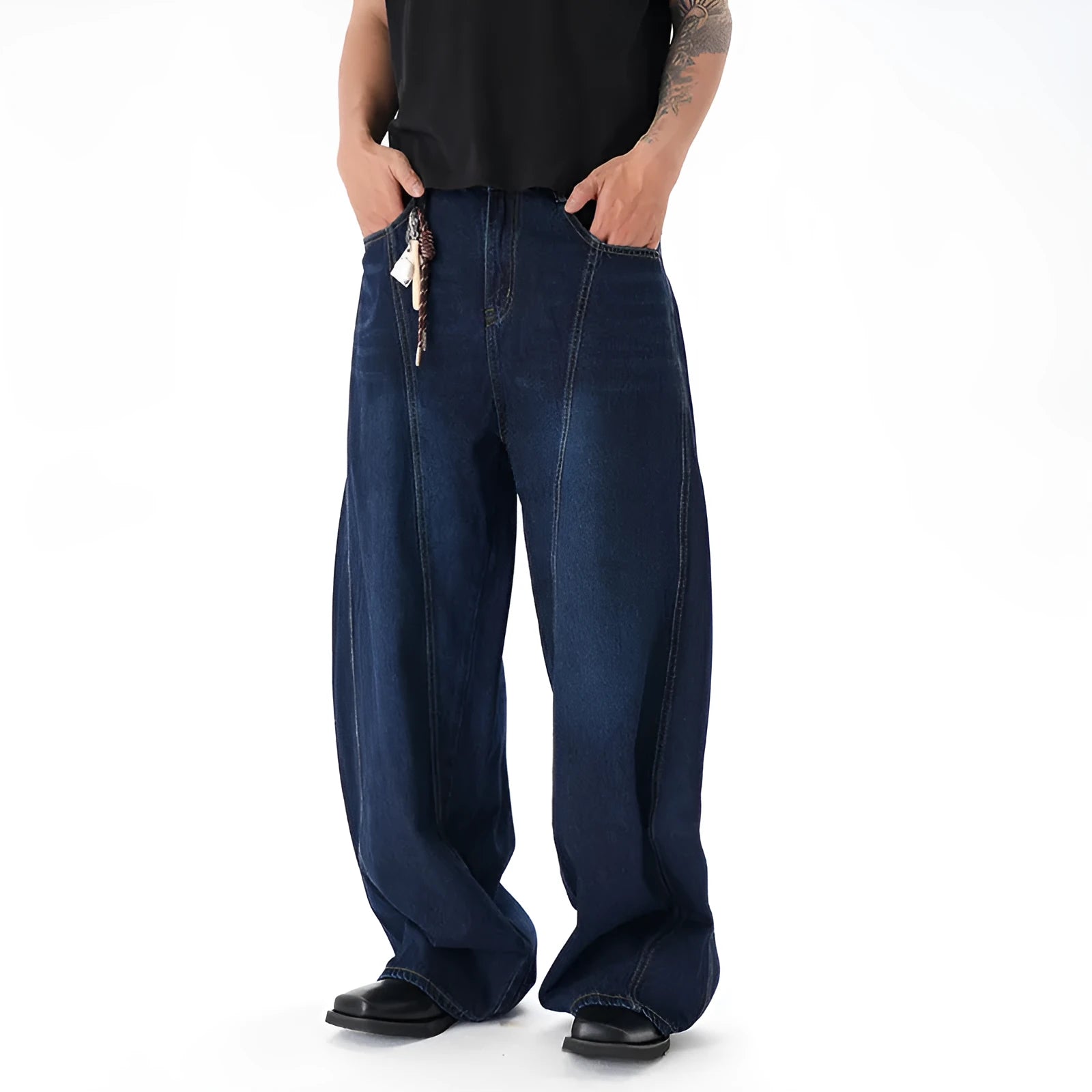 Dark blue washed distressed wide leg machete jeans on a model, showing the denim fabric and relaxed fit.