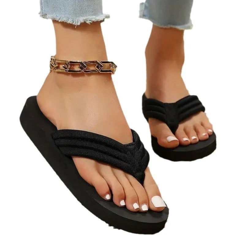 Black women's cotton flat slippers with ribbon detail and a non-slip EVA sole.