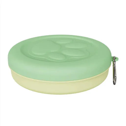 Portable plastic dog feeding bowl with integrated snack box compartment in light green colour
