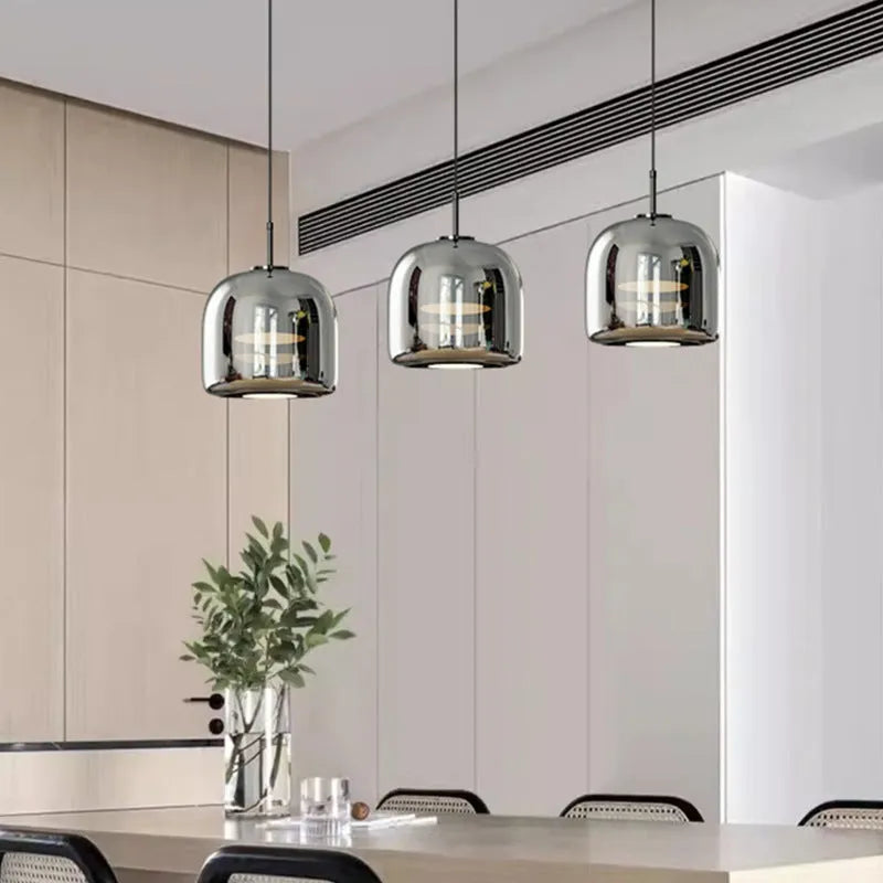 Italian minimalist glass chandelier with tricolor light in a dining room setting