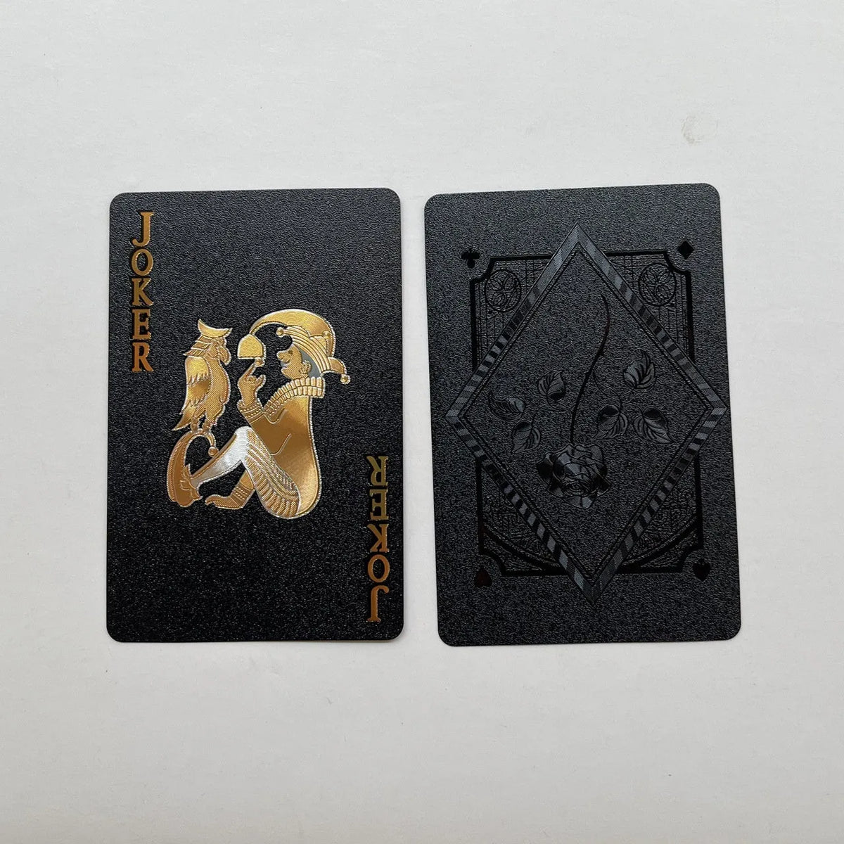Gold foil playing cards with black rose design, 57x87mm size, metallic finish