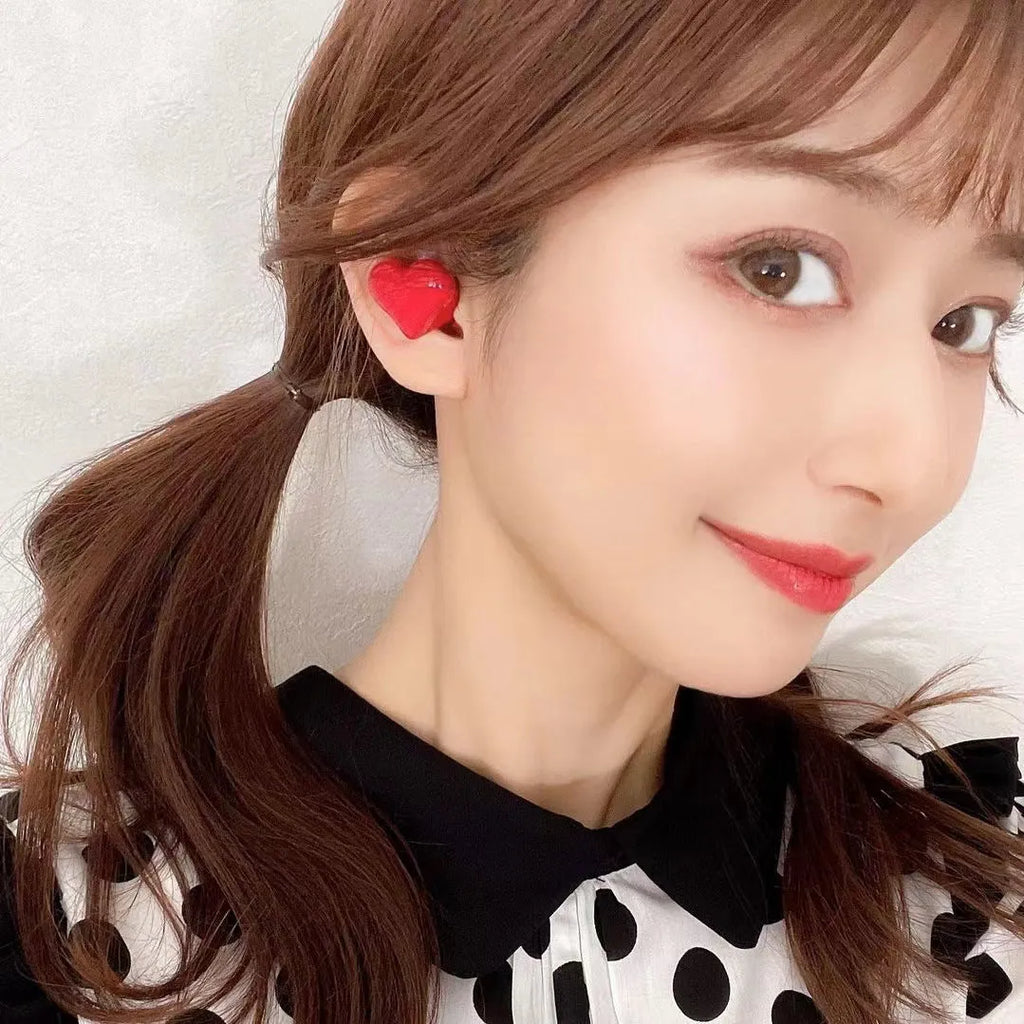 Heart-shaped wireless Bluetooth headphones in red and pink colour options with charging cable