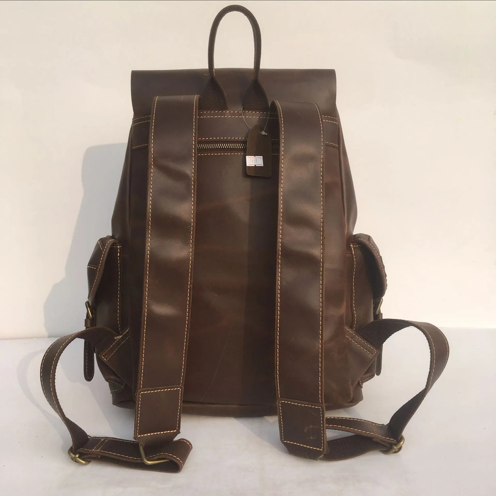 Brown genuine leather men's backpack with an air pillow belt system on the straps.
