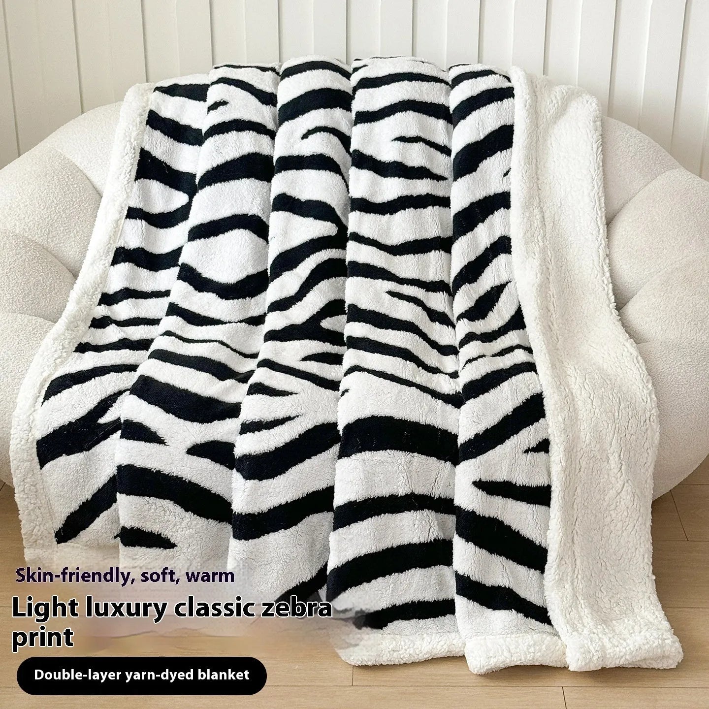 Double-layer taffeta blanket with woven leopard print pattern draped over sofa