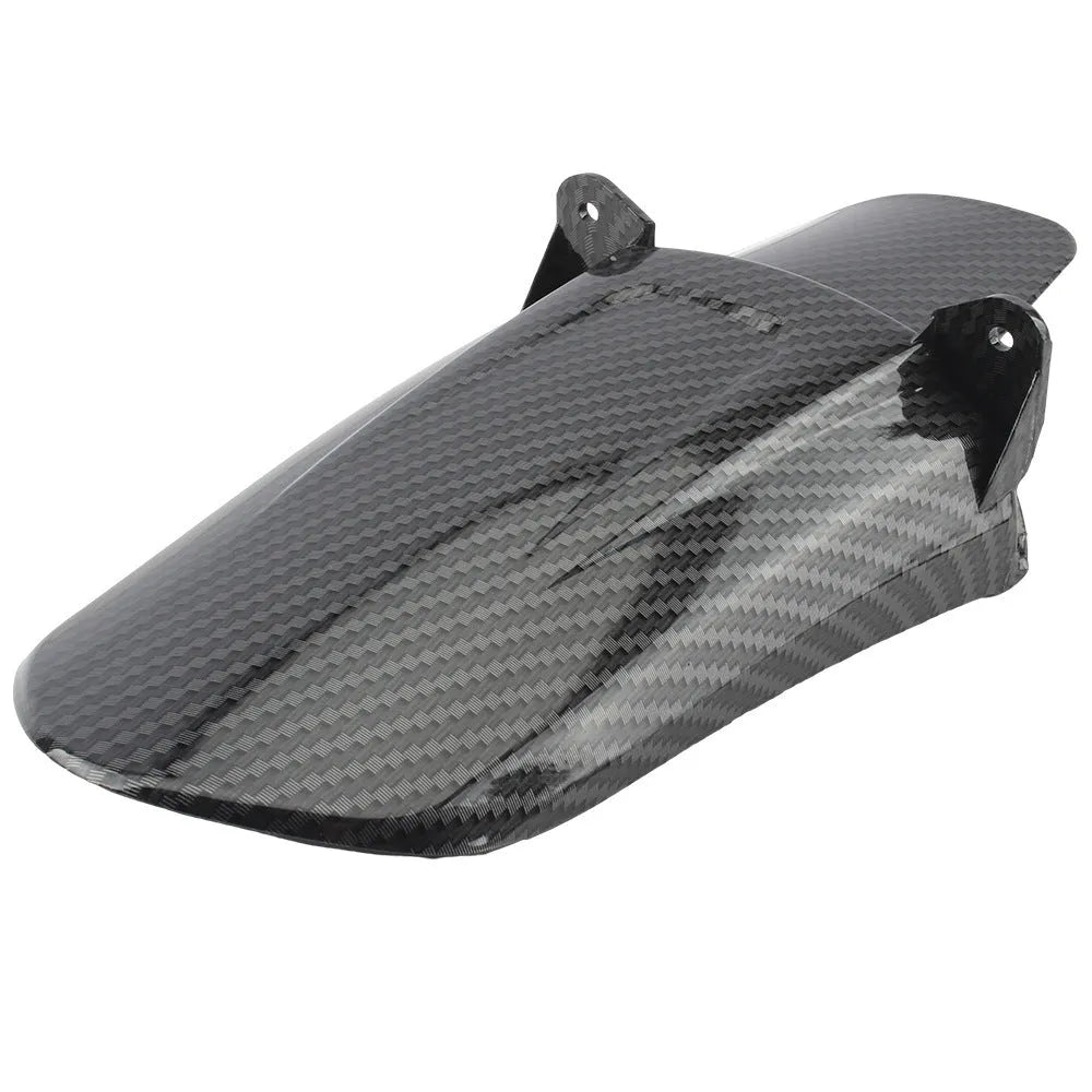 Carbon fibre rear shock absorber fender for a scrambling motorcycle.