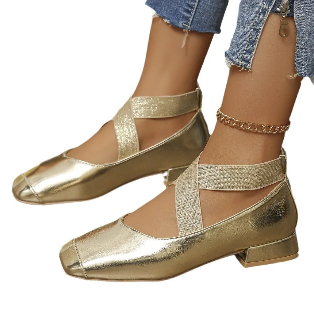 Gold slip-on square toe evening pumps with a low heel on a white background.