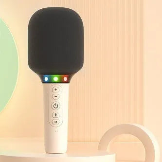 Pink Bluetooth children's handheld karaoke microphone with built-in speaker on white background
