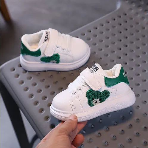 Children's black cartoon bear casual sports shoes with artificial leather upper and rubber sole.