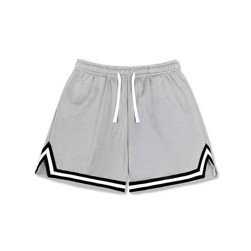 Man wearing loose-fit black polyester sports shorts for summer leisure activities.