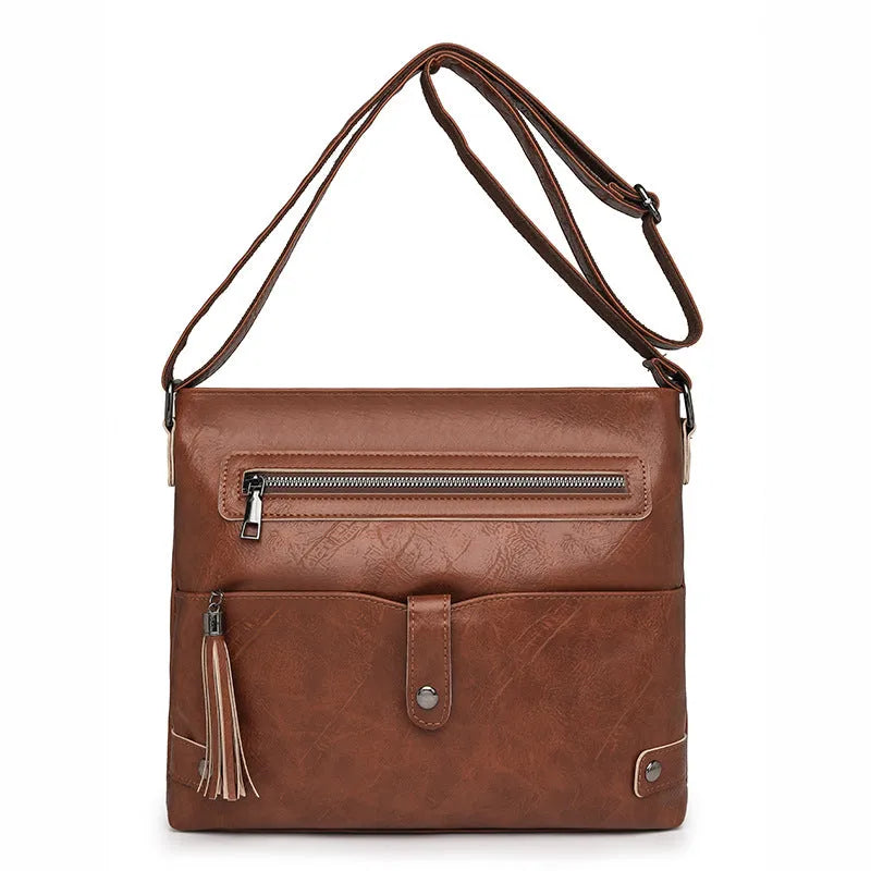 Women's soft PU tassel crossbody handbag in horizontal square shape with zipper compartments, available in beige, black, brown, coffee