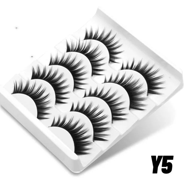 Box of natural style false eyelashes made from artificial fibre, showing thick dense lashes.