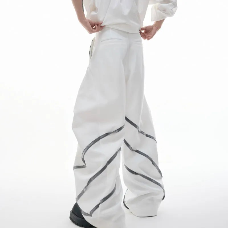 Men's polyester trousers with pleats and metal rivet detailing, shown in black and white colour options.