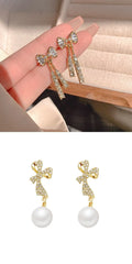 Gold butterfly earrings with rhinestones and bow element on alloy base