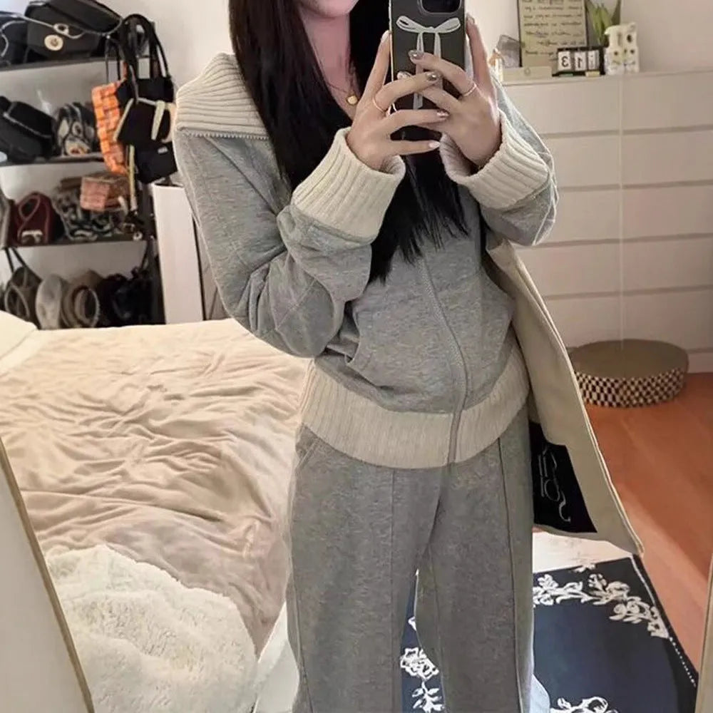 Light gray women's coat and wide leg trousers two-piece set with pockets on a plain background