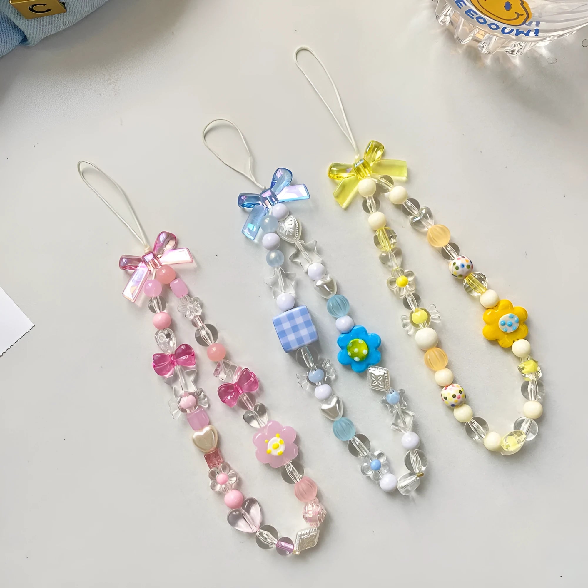 Colourful beaded flower mobile phone lanyard on rope with blue, pink, and yellow options