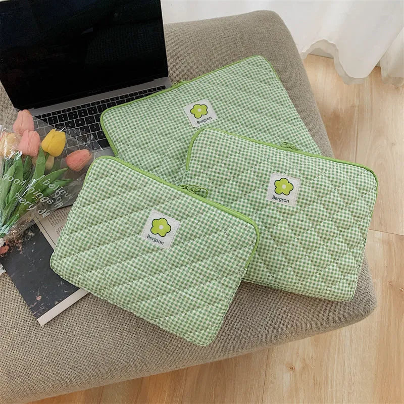 South Korean Ins cotton tablet handbag in green flower pattern with zipper closure on a table