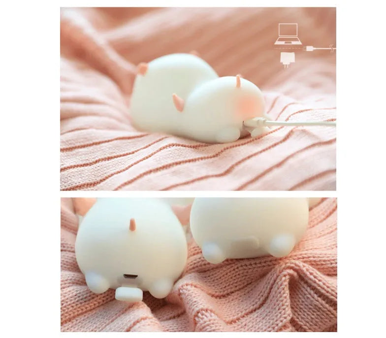 Blue silicone pig-shaped night light with sleeping design and USB charging port