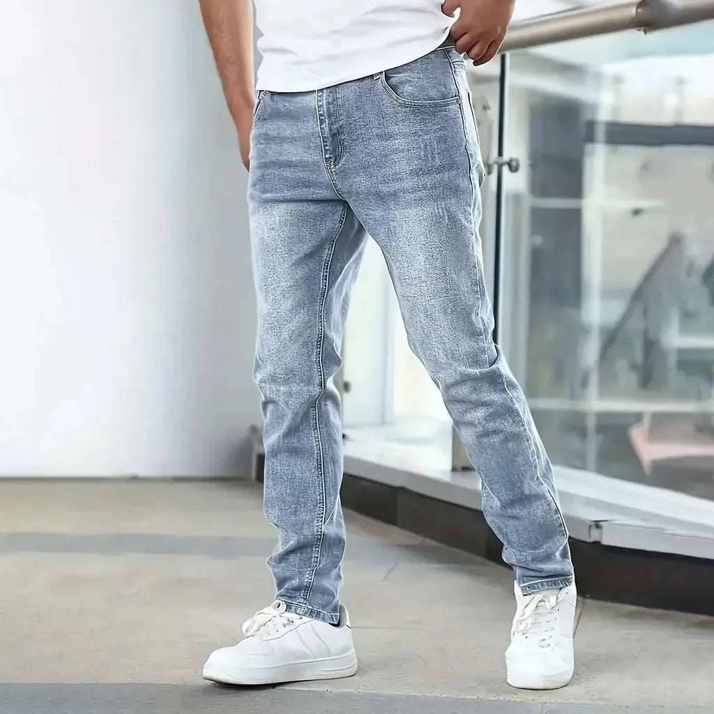 Men's straight leg jeans in stretch cotton denim showing high elasticity fabric and slim silhouette