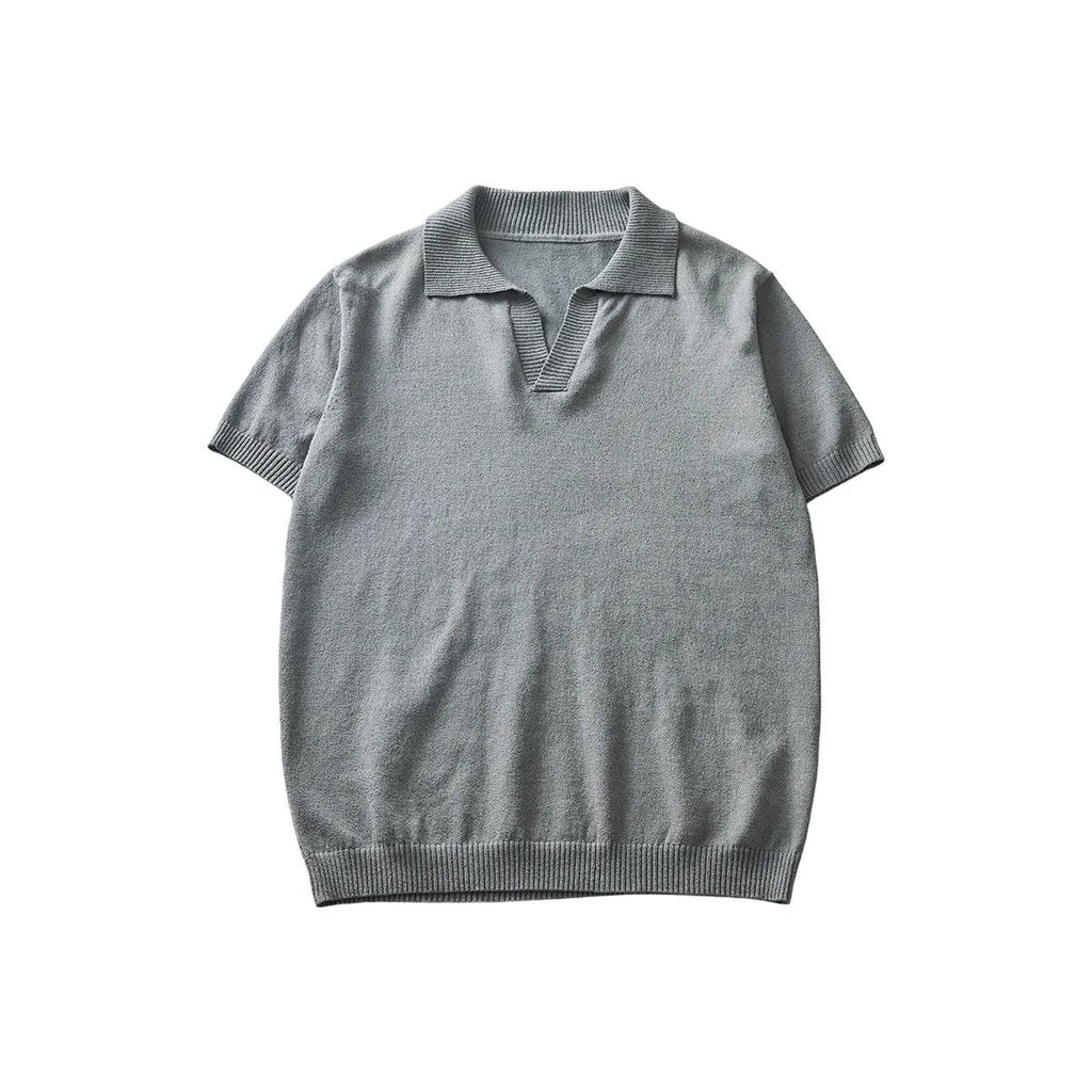 Man's short-sleeved knitted polo t-shirt in a solid colour on a hanger.
