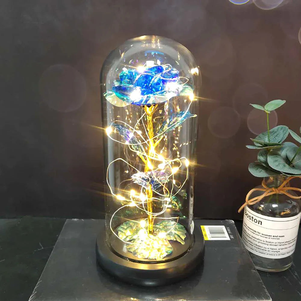 Artificial silk rose LED ornament with glass lampshade showing warm white lights, available in multiple colours.
