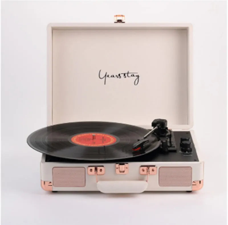 Leather-cased portable Bluetooth turntable for vinyl and film records in multiple colours.