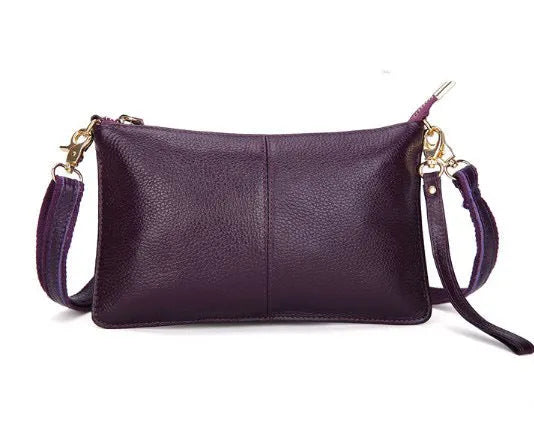 Lady's cowhide leather slant bag in apricot colour with hand strap and shoulder strap showing zipper compartments