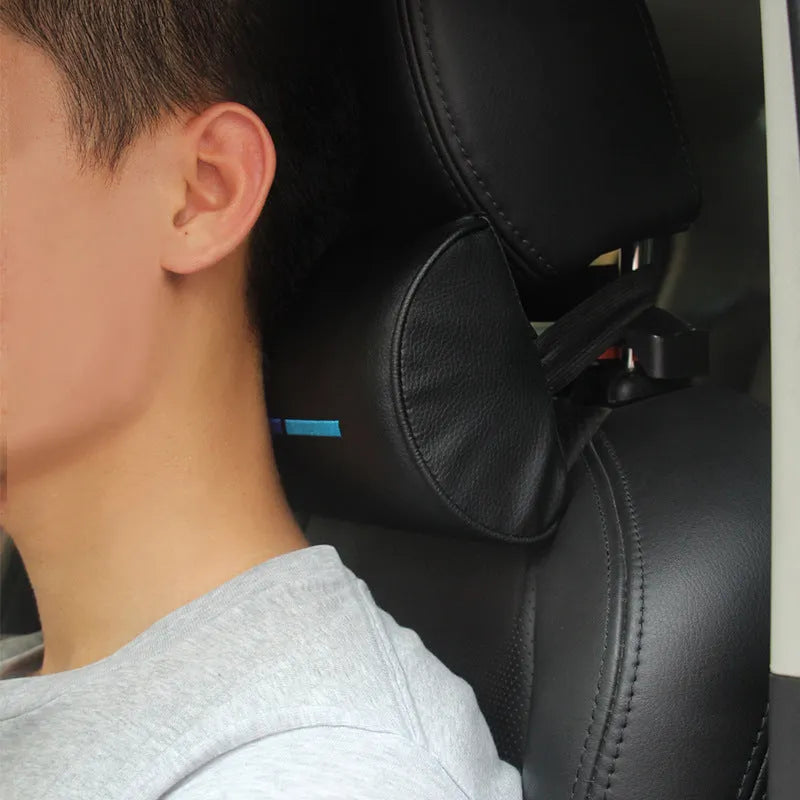 Black cotton car seat neck pillow on a car headrest for neck support