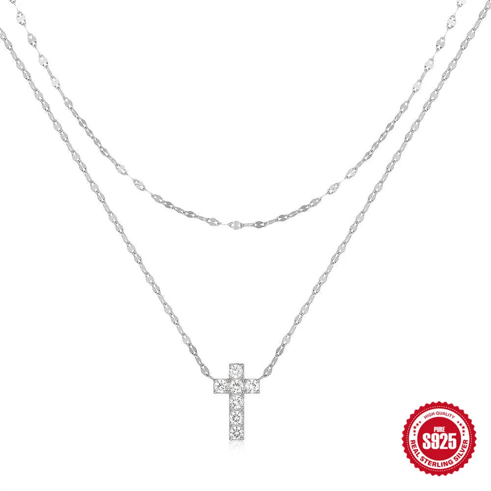 Sterling silver double layer cross pendant necklace with a clavicle chain in a gold tone finish.