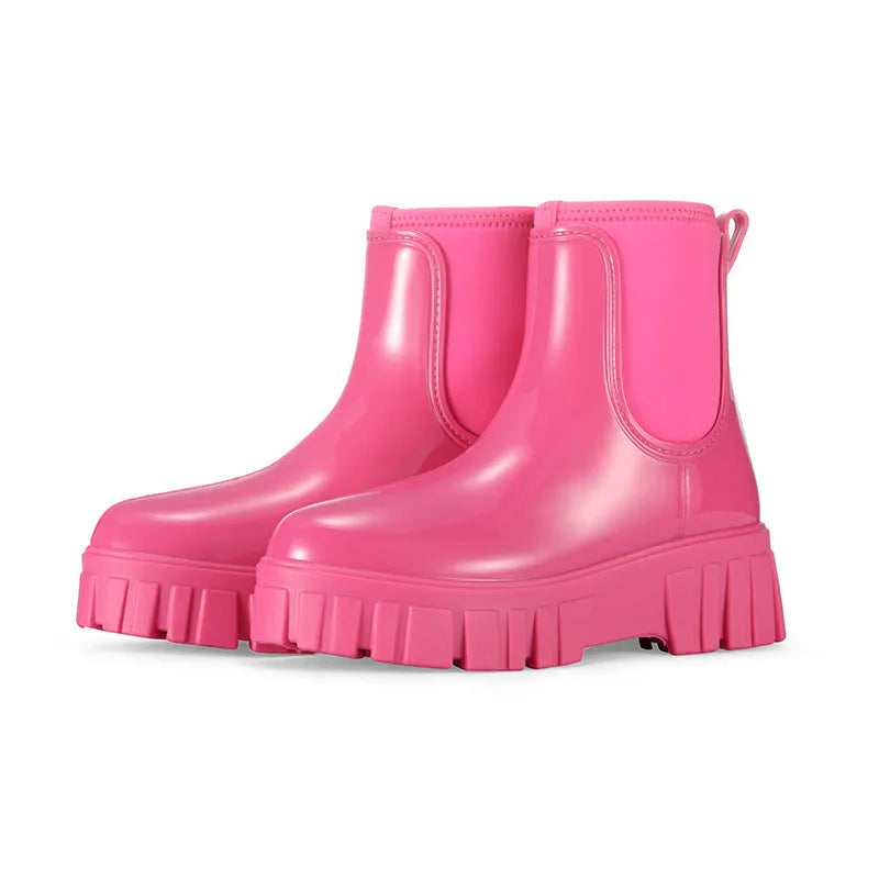 A pair of low tube PVC rain boots with a flat heel, shown in a solid colour on a white background.