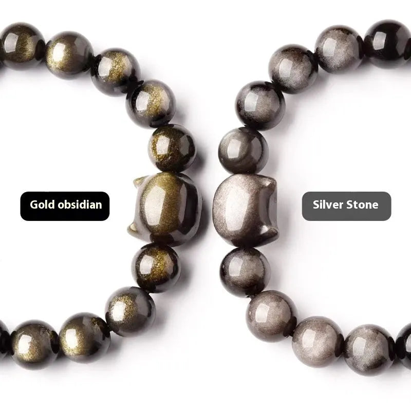 Obsidian cat head bracelet with round beads in gold or silver style, showing cat charm detail.