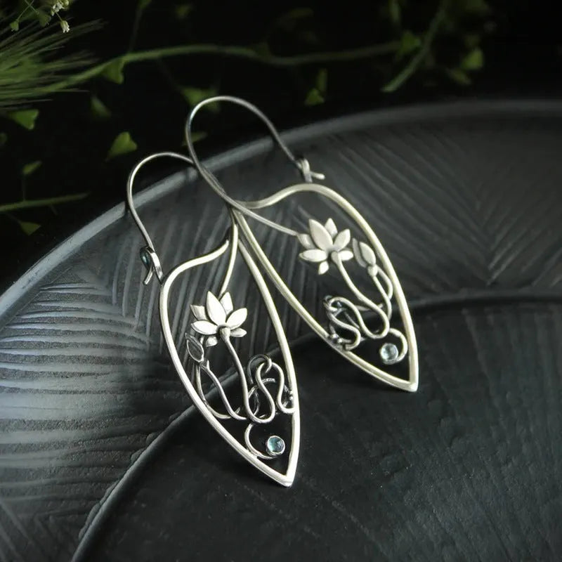 Silver women's earrings with lotus vine design featuring geometric floral patterns and circular rhinestones