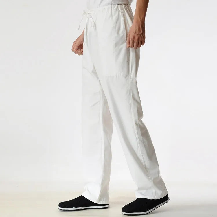 Man wearing beige pure cotton casual trousers with a drawstring waist and belt.