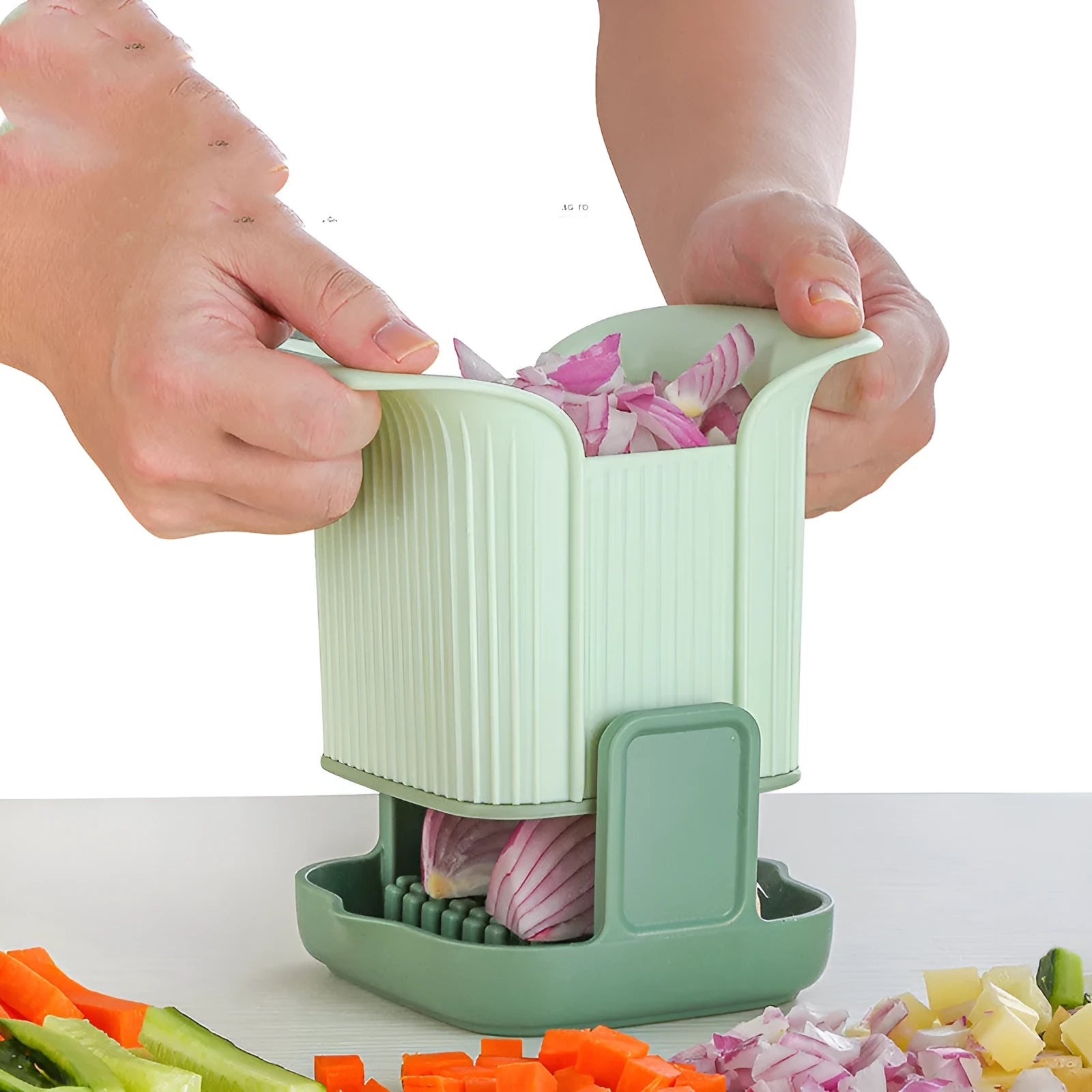 Green manual vegetable chopper with stainless steel cutting grid for slicing onions, potatoes, radishes and cucumbers