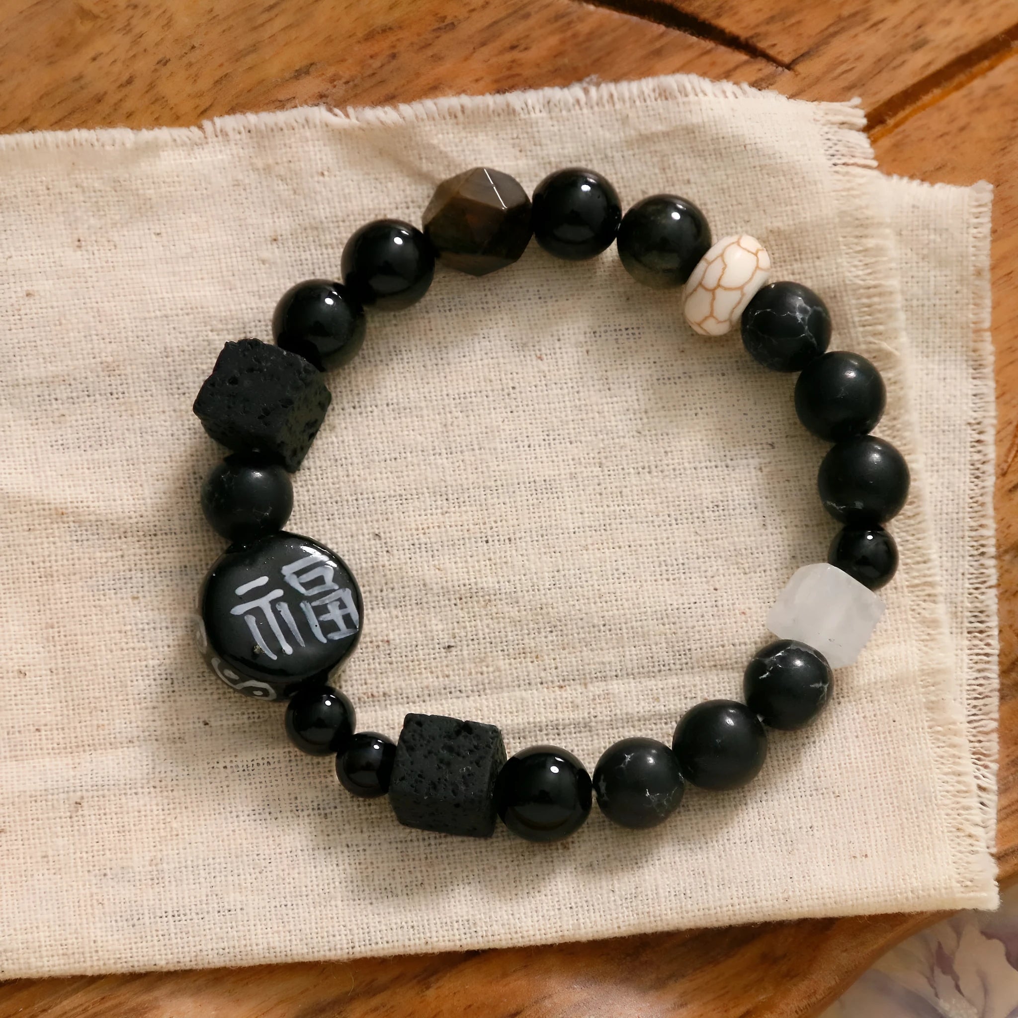 Hand-woven natural black agate and ceramic bracelet with geometric round bead design