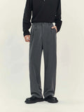 Men's black loose straight-leg business casual trousers on a hanger showing the draping style fit.