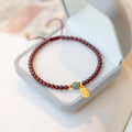 Red rope bracelet with strawberry quartz and garnet beads, hand-woven adjustable design
