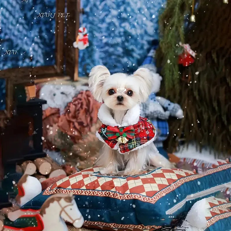 A red festive pet scarf with a bell pattern fastened around a dog's neck with an elastic collar.