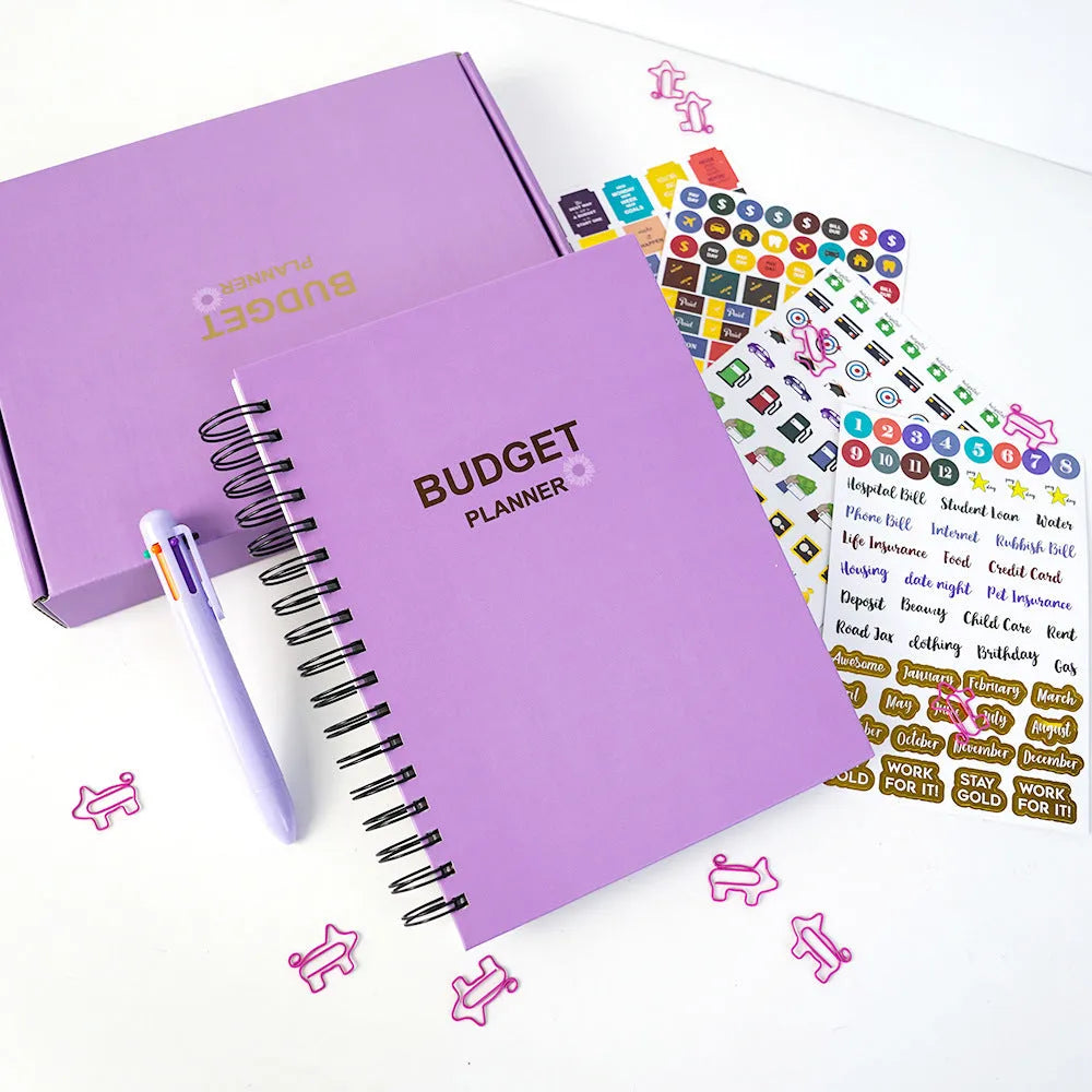 J12 purple coil-bound financial planning notebook with budget stickers and paper clips on Daolin paper pages