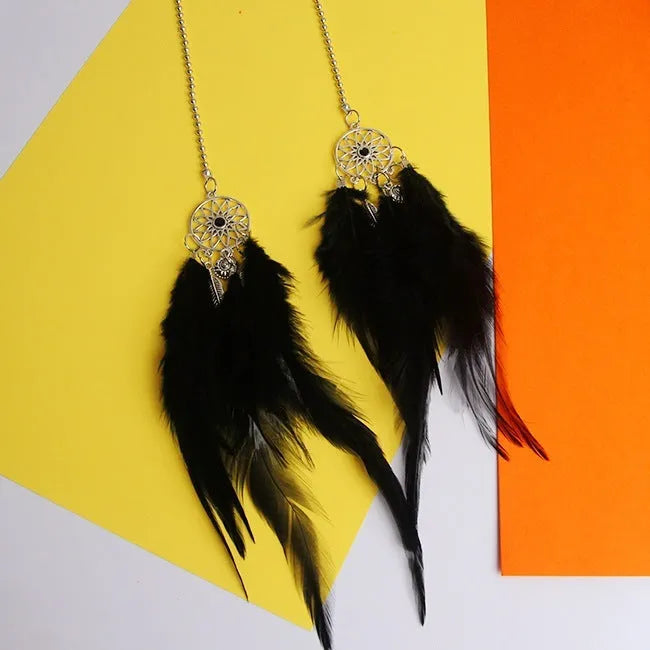 Dreamcatcher car ornament with metal frame and feather in one of six colours on car interior