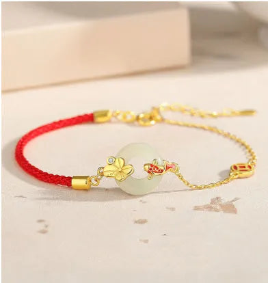 925 sterling silver red rope bracelet with a gold koi peace buckle safety clasp.