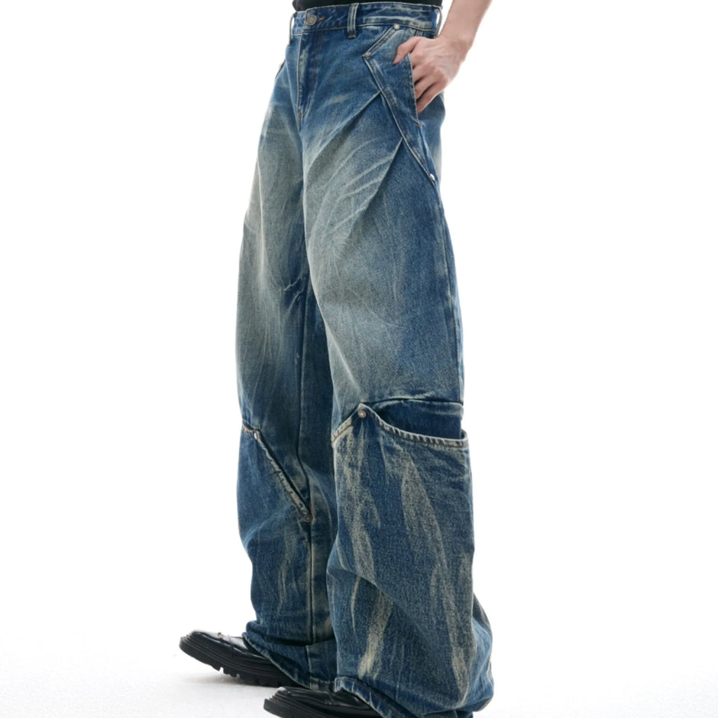 Men's verdant blue jeans with retro washed burst pattern and curved knife silhouette in loose fit