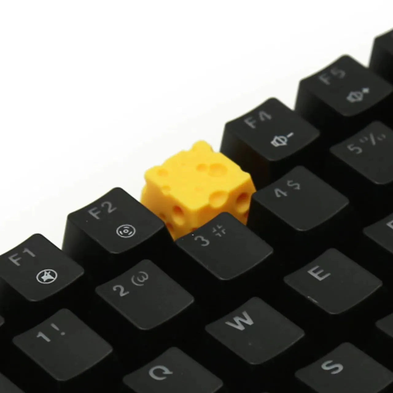 Yellow resin mechanical keyboard keycap with a detailed cheese design for MX-style switches.