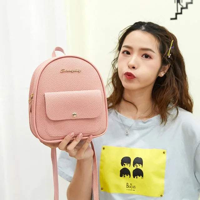 Women's small black PU shoulder backpack with a letter purse and zipper closure.