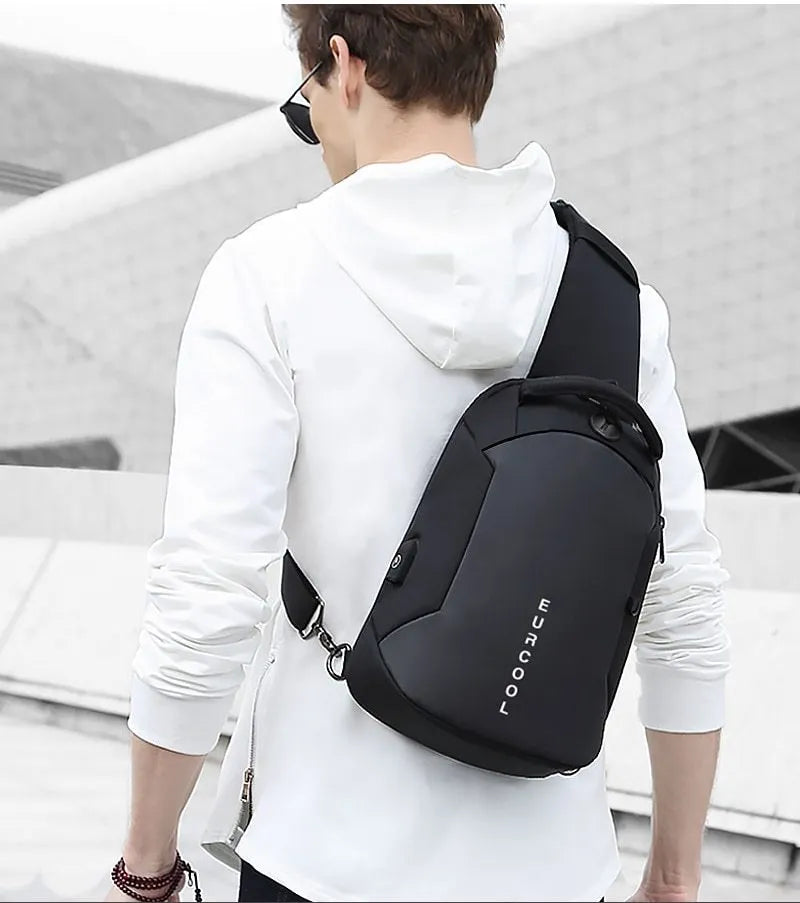 Men's black Oxford crossbody bag with single adjustable shoulder strap and USB charging port, front view