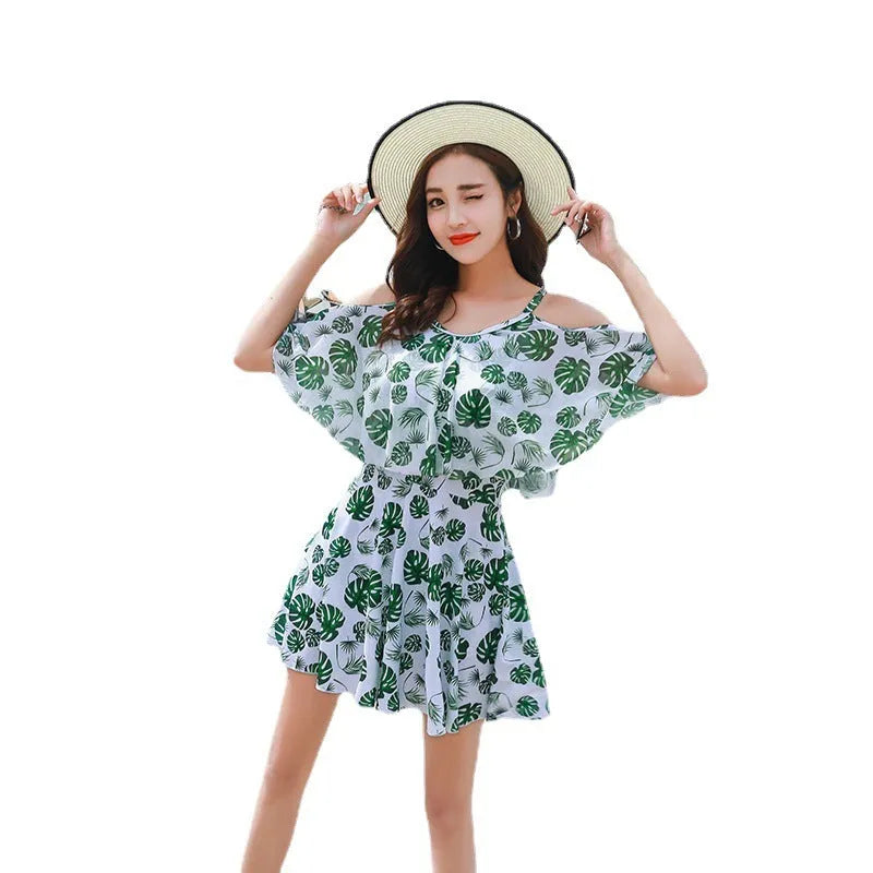 Women's green leaf style printed one-piece swimsuit laid flat.
